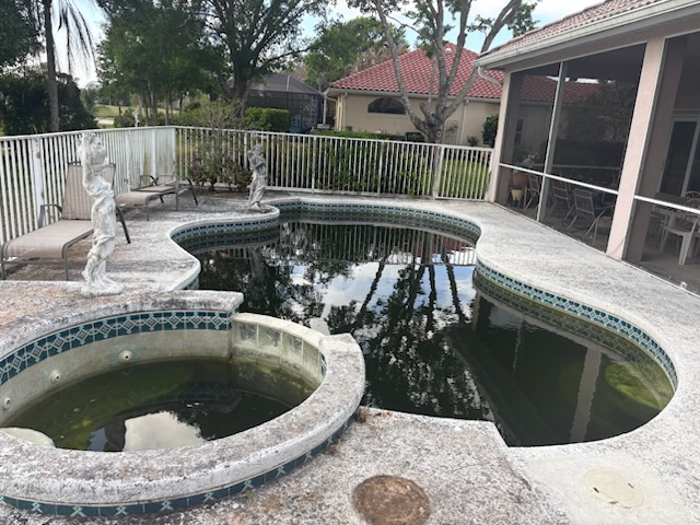 Gated pool and spa overtaken by dark green algae before professional cleaning